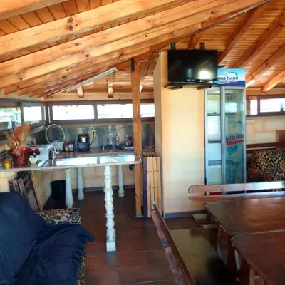 a kitchen and living room with a sink and a tv at Къща за гости 