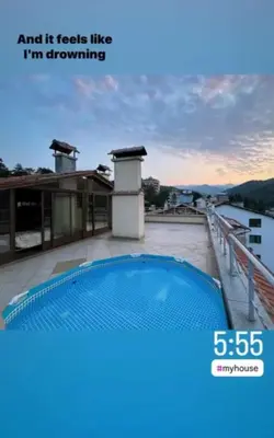 a swimming pool on the roof of a house at Къща за гости 