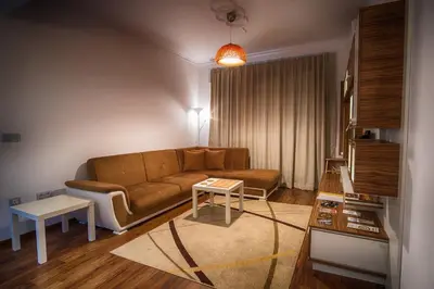 a living room with a couch and a table at Sunshine Sofia in Sofia
