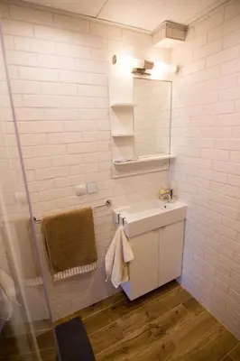 a white bathroom with a sink and a mirror at Sunshine Sofia in Sofia