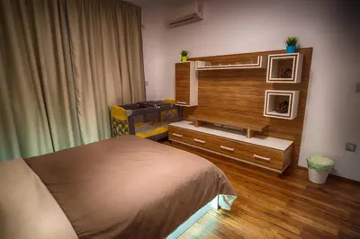 a bedroom with a bed and a dresser and a mirror at Sunshine Sofia in Sofia
