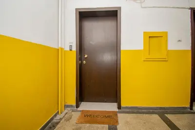 a yellow and white wall with a brown door at Casa Dolce Far Niente, 2BATH&2BED, PARKING, Vitosha blvd in Sofia