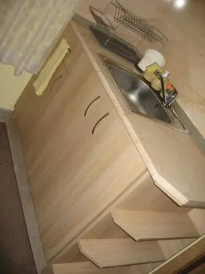 a kitchen counter with a sink and wooden cabinets at Guest House Lori in Teteven