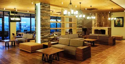 a lobby with couches and tables and a fireplace at Hot Springs Medical and SPA in Banya