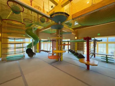 a childrens play room with a slide and swings at Hot Springs Medical and SPA in Banya