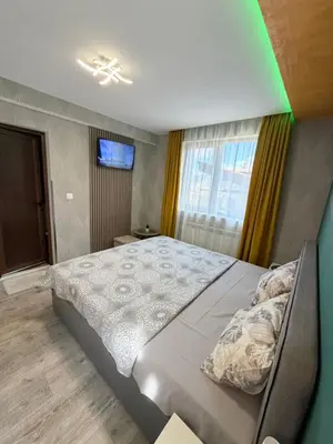 a bedroom with a large bed and a window at Къща за гости Мурите in Sapareva Banya