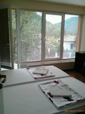 a table with two napkins on it with two windows at Vila Bachkovo in Bachkovo