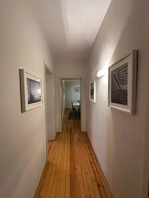 a hallway with two pictures on the walls and a table at CityCentre Gem with Free Parking in Plovdiv
