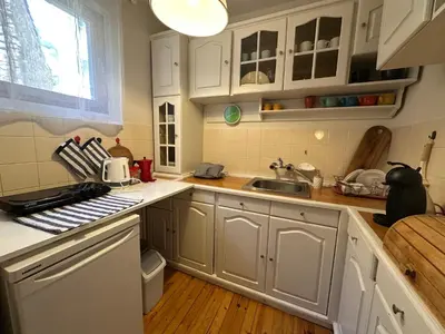 a kitchen with white cabinets and a sink at CityCentre Gem with Free Parking in Plovdiv