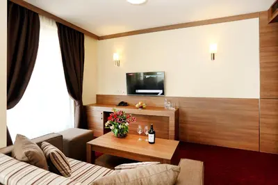 a living room with a couch and a table at Hotel COOP, Sofia in Sofia