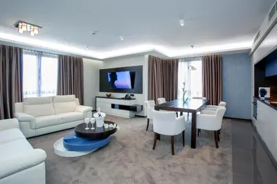 a living room with a white couch and a table at VIKO Boutique Apart Hotel in Sofia