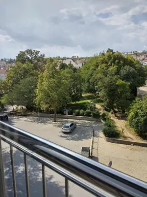 a car parked in a parking lot next to trees at Vila Nova in Sandanski