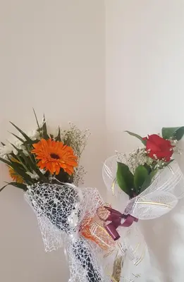 two bouquets of flowers in white net at Guest House - Batak in Batak
