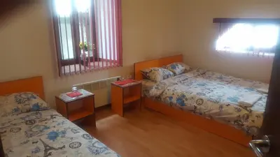 a small room with two beds and two windows at Guest House - Batak in Batak