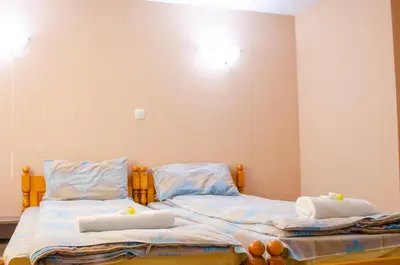 a bedroom with two beds with towels on them at Guest House Vasilena Самостоятелно наемане FREE PARKING in Sapareva Banya