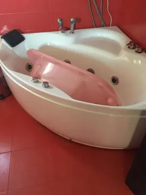 a pink bath tub in a red bathroom at Guest House Pautalya in Kyustendil
