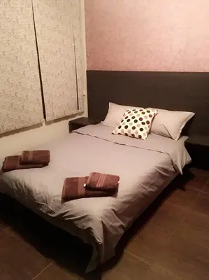 a bed with two pillows on it in a room at Guest House Pautalya in Kyustendil