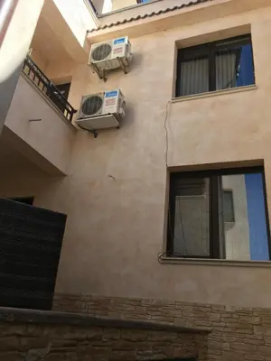 a building with two air conditioners on the side of it at Guest House Pautalya in Kyustendil