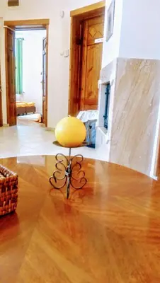 a yellow chair sitting in the middle of a living room at Time Traveling Apartment Sofia City in Sofia