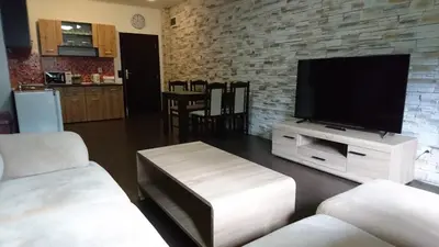 a living room with a flat screen tv on a stand at TES Flora Apartments in Borovets