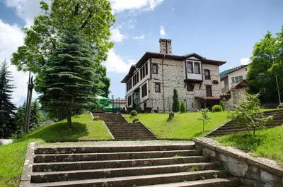 an old stone house with stairs in front of it at Petko Takov's House in Smolyan