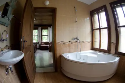 a large bathroom with a tub and a sink at Petko Takov's House in Smolyan