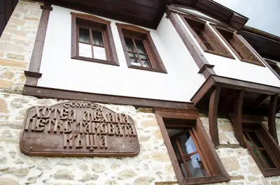 a building with a sign on the side of it at Petko Takov's House in Smolyan