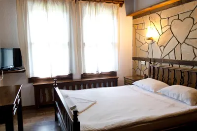 a bedroom with a bed with a heart mural on the wall at Petko Takov's House in Smolyan