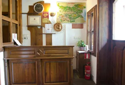 a room with a wooden cabinet and a clock on the wall at Petko Takov's House in Smolyan