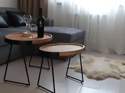 a couple of tables with wine glasses and a couch at PM Services Borovets Garden Apartments in Borovets