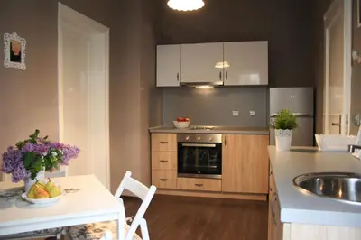 a kitchen with a sink and a counter with a table at Yavor Apartment in Sofia