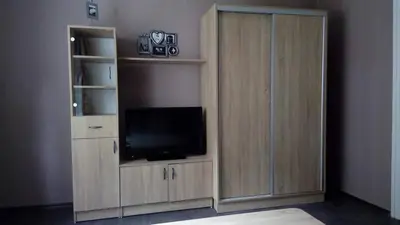 a large wooden entertainment center with a television in it at Yavor Apartment in Sofia