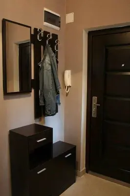 a room with a dresser and a mirror and a door at Yavor Apartment in Sofia