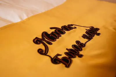 a close up of a word written on a bed at MIDAS - Borov Park in Velingrad
