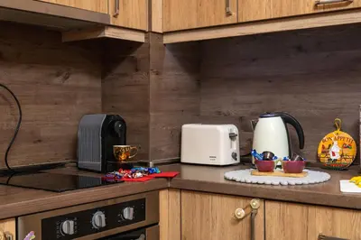 a kitchen counter with a coffee maker and a toaster at MIDAS - Borov Park in Velingrad