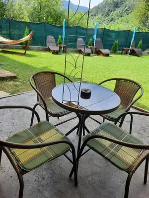 a table with two chairs and a table with a bowl on it at Guest House Lazar Raykov in Ribarica