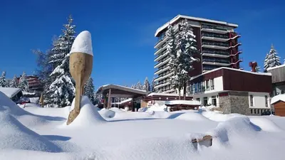 a wooden spoon sticking out of a pile of snow at Grand Hotel Murgavets in Pamporovo