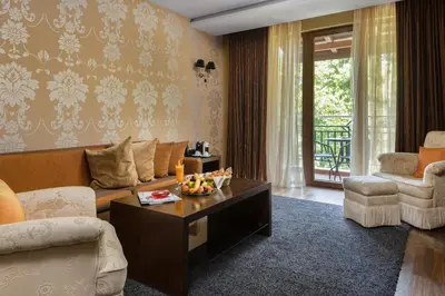 a living room with a couch and a table at Pirin Park Hotel in Sandanski