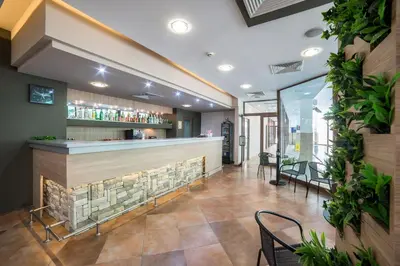 a bar in a restaurant with plants on the wall at Devin Spa Hotel in Devin