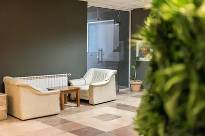 a waiting room with two chairs and a table at Devin Spa Hotel in Devin