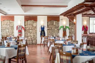 a dining room with tables and dresses on the wall at Devin Spa Hotel in Devin