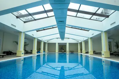 a large swimming pool with a large ceiling at Parklands Hotel & Pool in Bansko