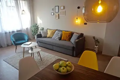 a living room with a couch and a table at Sofia City Home in Sofia