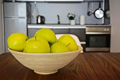 a bowl of green apples on a table in a kitchen at Sofia City Home in Sofia