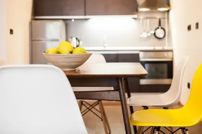 a kitchen with a table with a bowl of fruit on it at Sofia City Home in Sofia