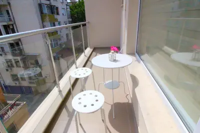 a balcony with a table and two chairs on it at Lilly Apartments in Plovdiv