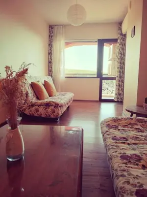 a living room with a couch and a glass table at Ma-Bebe SPA Suite - Thermal Jacuzzi and Family Comfort in Pchelin