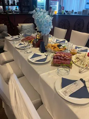 a long table with plates of food on it at Hotel Consul in Sofia