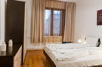 a bedroom with a large bed and a window at VIP Apartments Sofia in Sofia