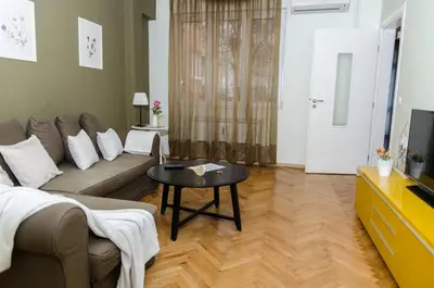 a living room with a couch and a table at VIP Apartments Sofia in Sofia